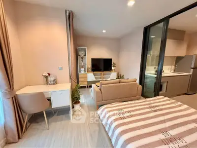 Modern studio apartment with cozy living area and open kitchen layout.