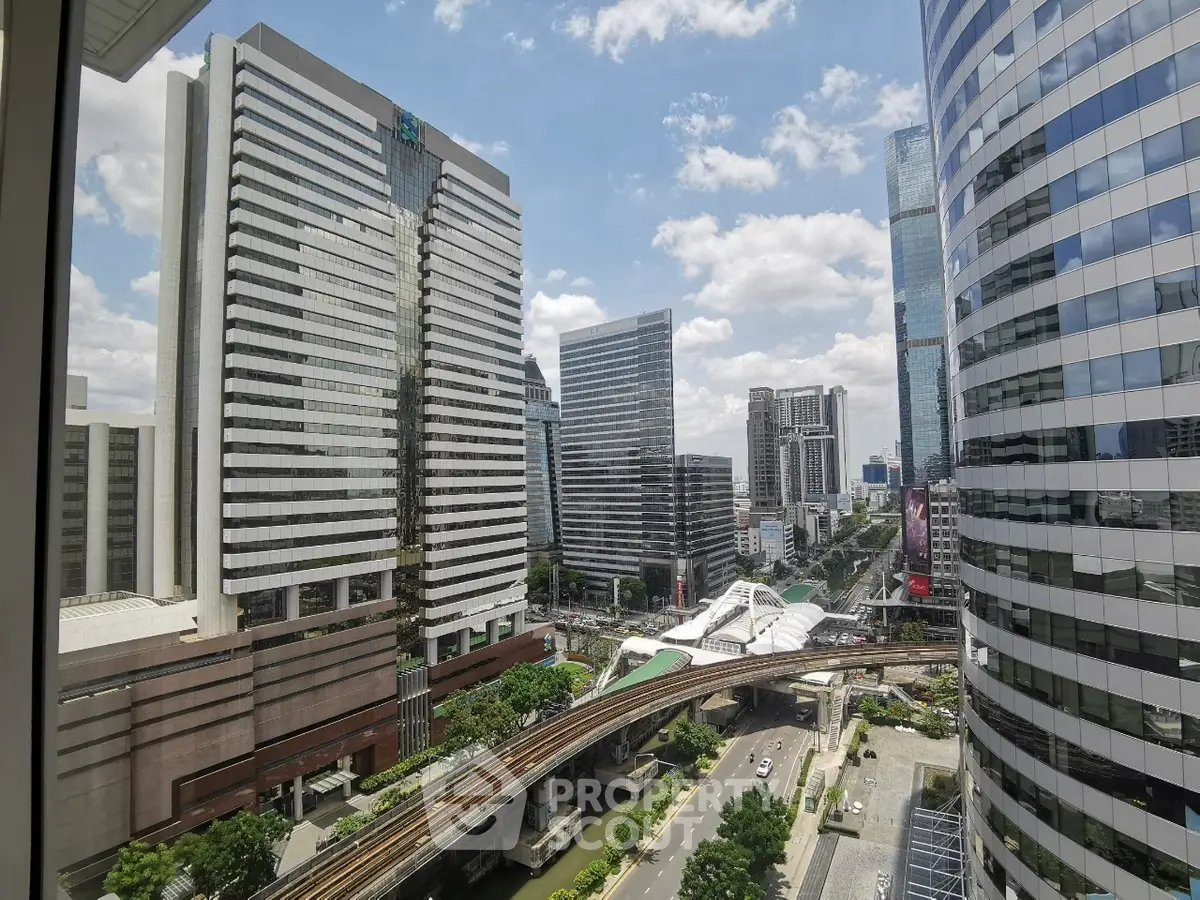 Stunning cityscape view from a high-rise building showcasing modern architecture and urban transit.