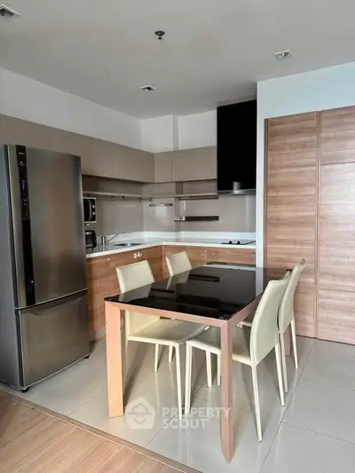 Modern kitchen with sleek design, featuring stainless steel appliances and a stylish dining area.