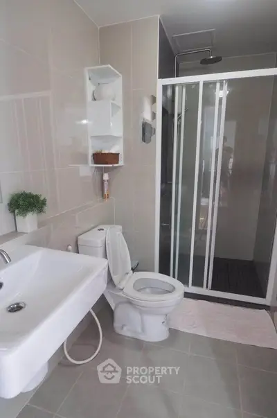 Modern bathroom with sleek shower and elegant fixtures in a contemporary home.