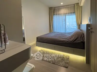 Modern bedroom with ambient lighting and large window in stylish apartment