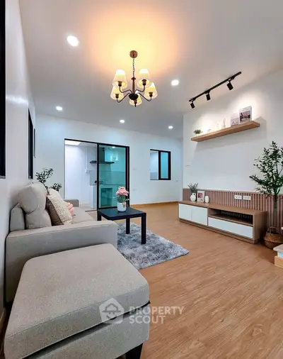Modern living room with elegant chandelier and cozy seating area