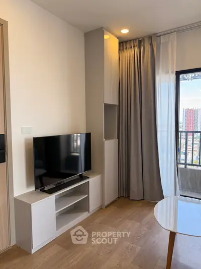 Modern living room with sleek TV stand and city view balcony