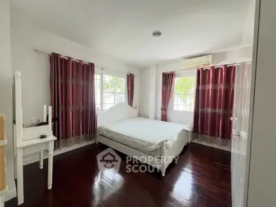 Spacious bedroom with elegant decor and natural light