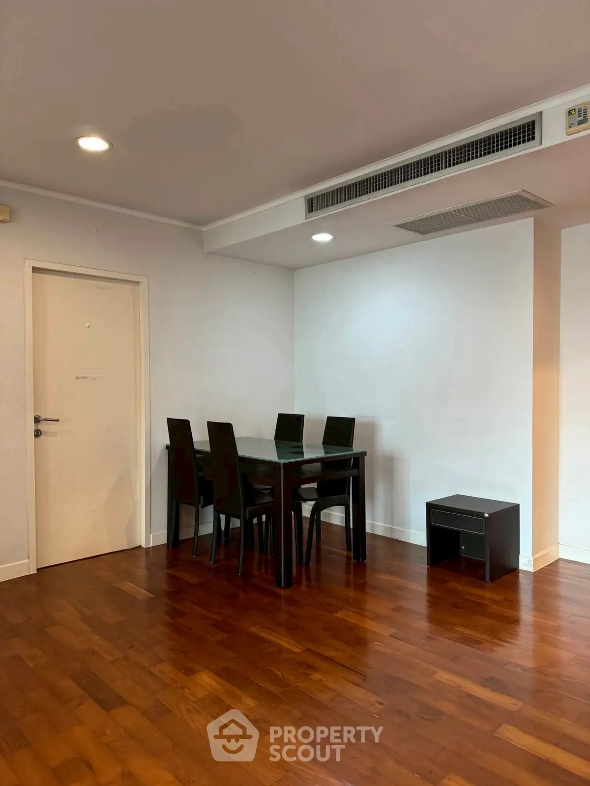 Elegant dining area with wooden flooring and modern furniture