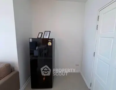 Modern interior with sleek black refrigerator and minimalistic decor
