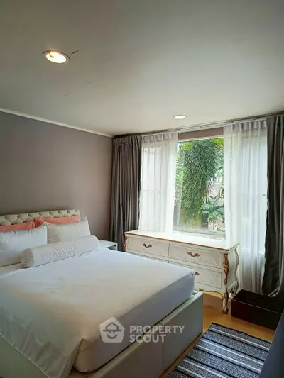Cozy bedroom with elegant decor and large window view