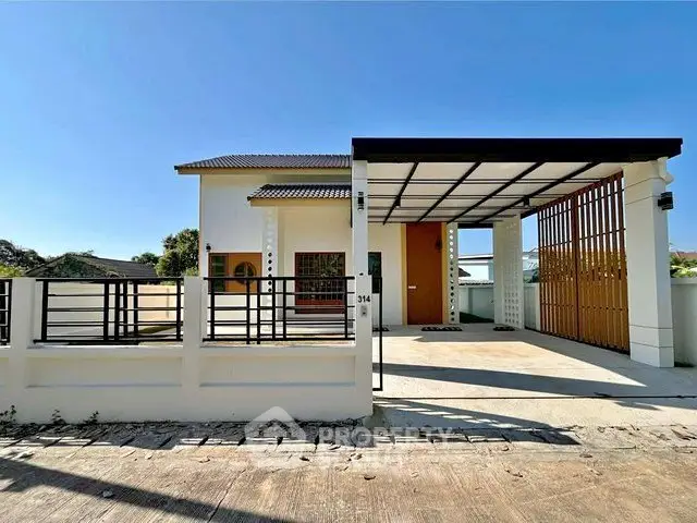 Modern single-story house with carport and sleek design in a sunny neighborhood.