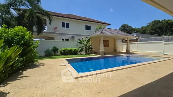 Luxurious villa with private pool and lush garden, perfect for tropical living.