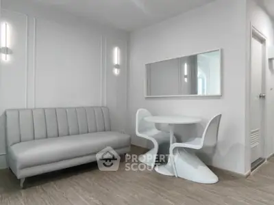 Modern minimalist living room with sleek sofa and stylish dining set