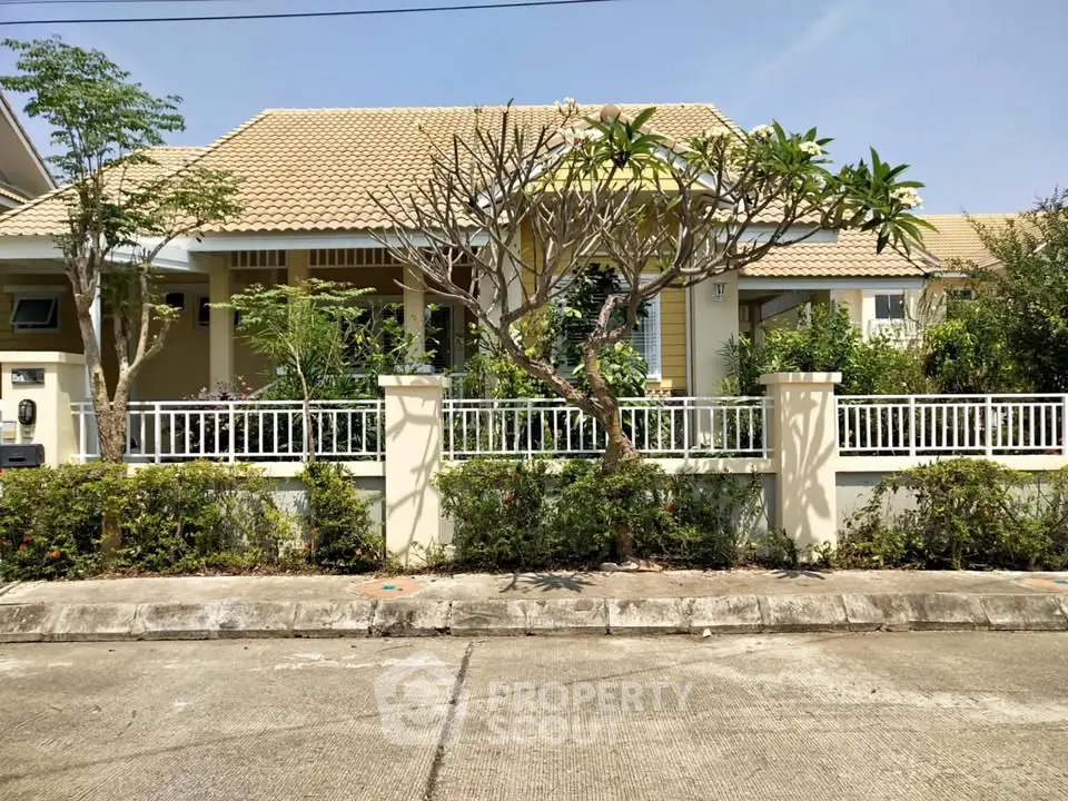 Charming suburban house with lush garden and white picket fence