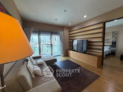 Spacious living room with modern decor and city view from large windows.