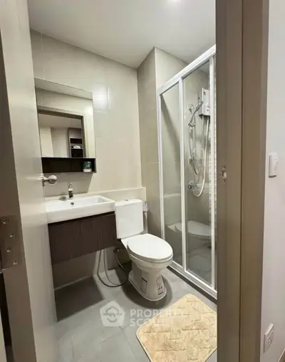 Modern bathroom with sleek shower and contemporary fixtures in a stylish apartment.
