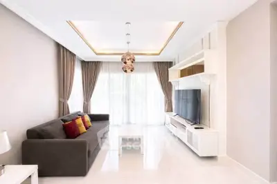 Modern living room with sleek design, large windows, and stylish decor for a bright and inviting atmosphere.