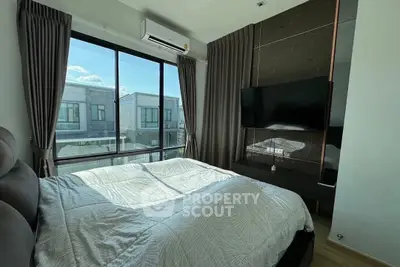 Modern bedroom with large window and stylish decor