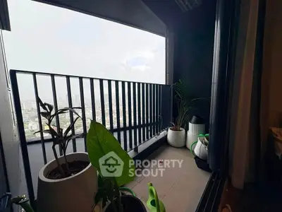 Modern balcony with city view and potted plants, perfect for relaxation.