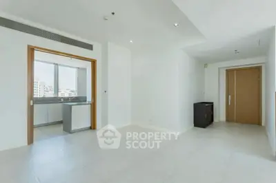 Spacious modern apartment interior with open layout and large windows.
