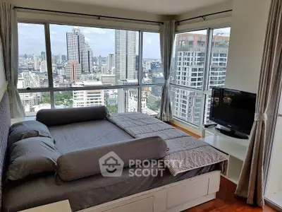 Luxurious bedroom with panoramic city views in high-rise apartment