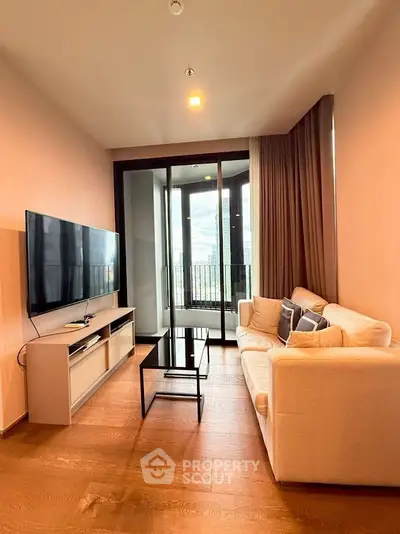 Modern living room with large TV and balcony view in luxury apartment