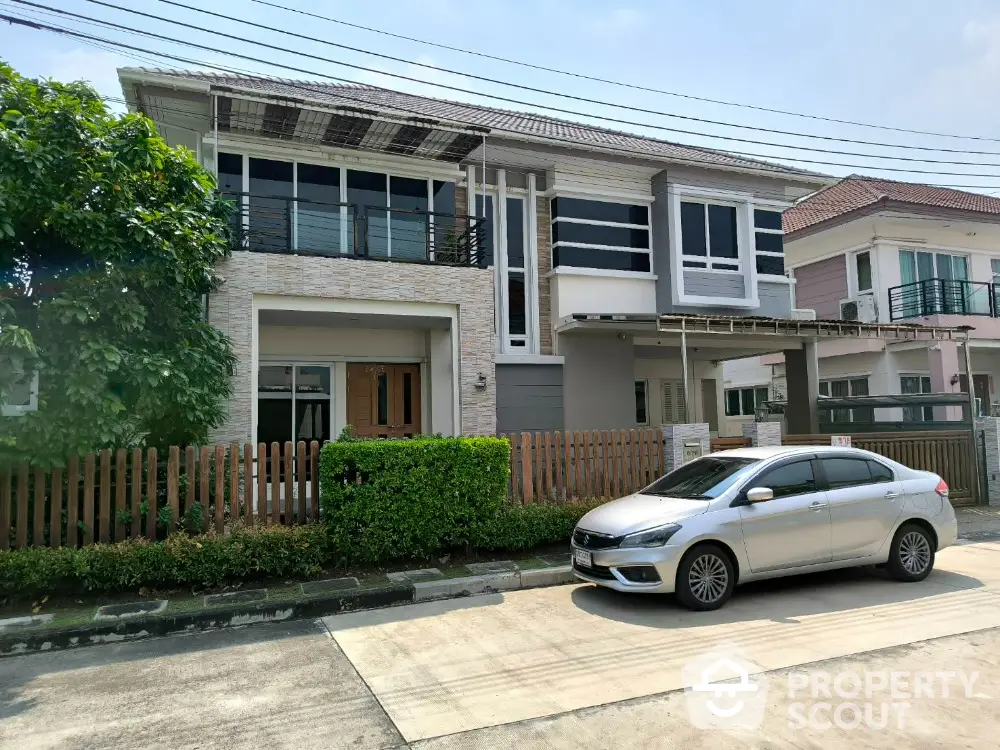 Modern two-story house with sleek design and spacious driveway