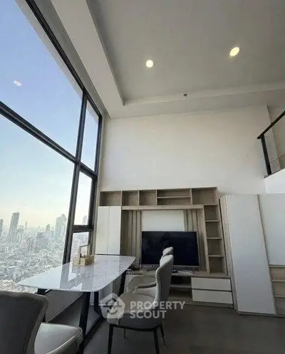 Stunning high-rise living room with floor-to-ceiling windows and city skyline view.