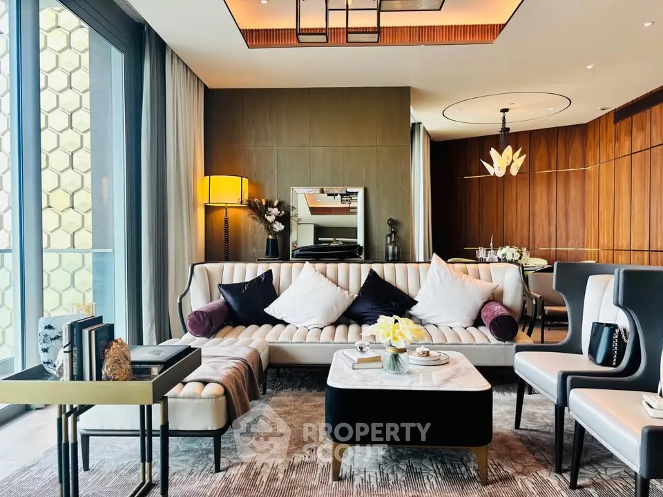 Luxurious modern living room with elegant decor and large windows offering natural light.