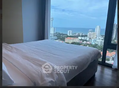 Luxurious bedroom with stunning ocean view in high-rise apartment