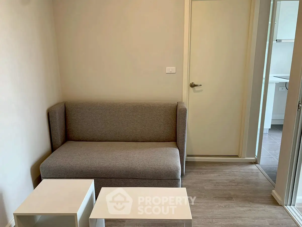 Cozy living room with modern gray sofa and minimalist tables