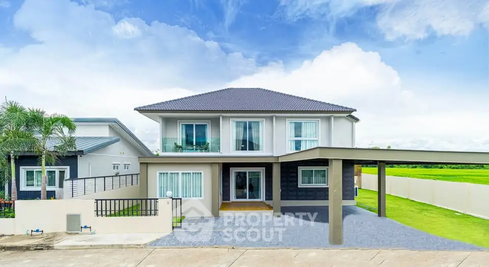 Stunning modern two-story house with spacious driveway and lush green surroundings.