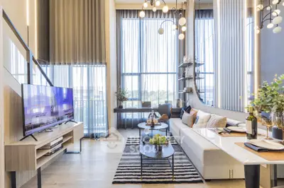 Luxurious modern living room with high ceilings, large windows, and elegant decor, perfect for entertaining.
