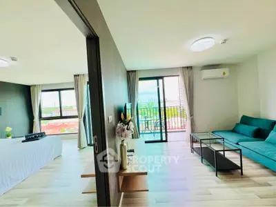 Spacious modern apartment with open living area and balcony offering stunning city views.