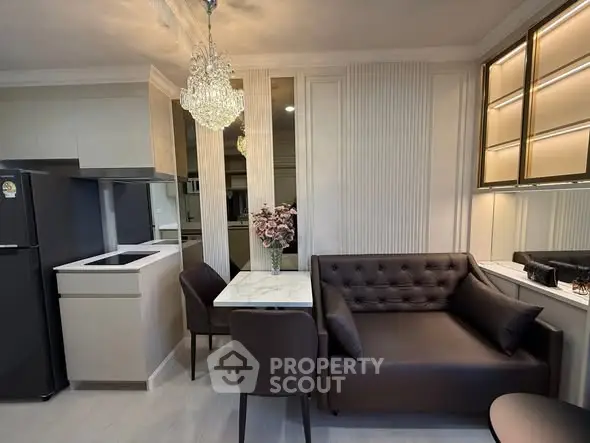 Modern kitchen and dining area with elegant chandelier and sleek furniture