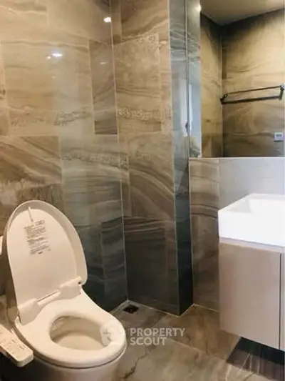 Luxurious modern bathroom with sleek tile design and high-end fixtures.