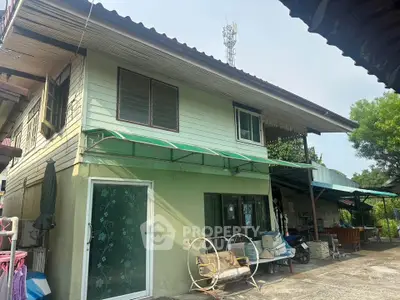 Charming two-story house with spacious outdoor area and rustic design elements.