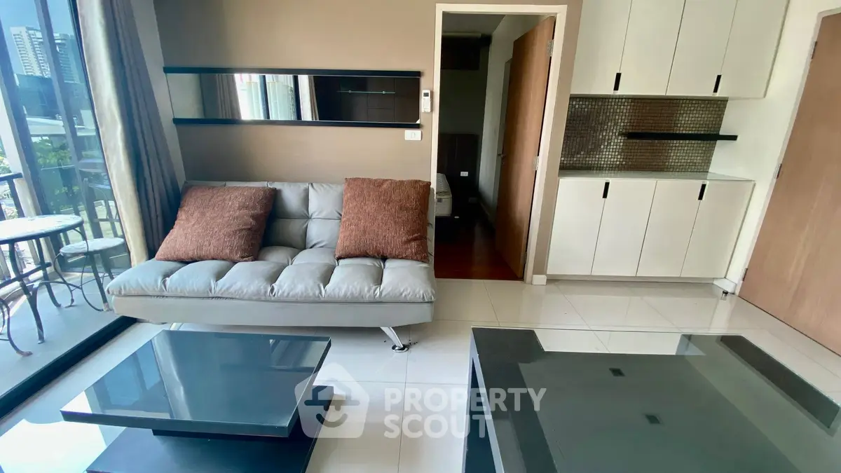Modern living room with sleek furniture and city view balcony