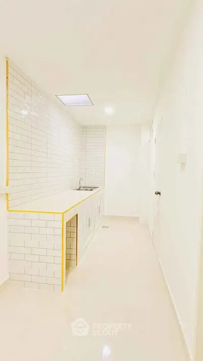 Sleek modern kitchen with white subway tiles and minimalist design