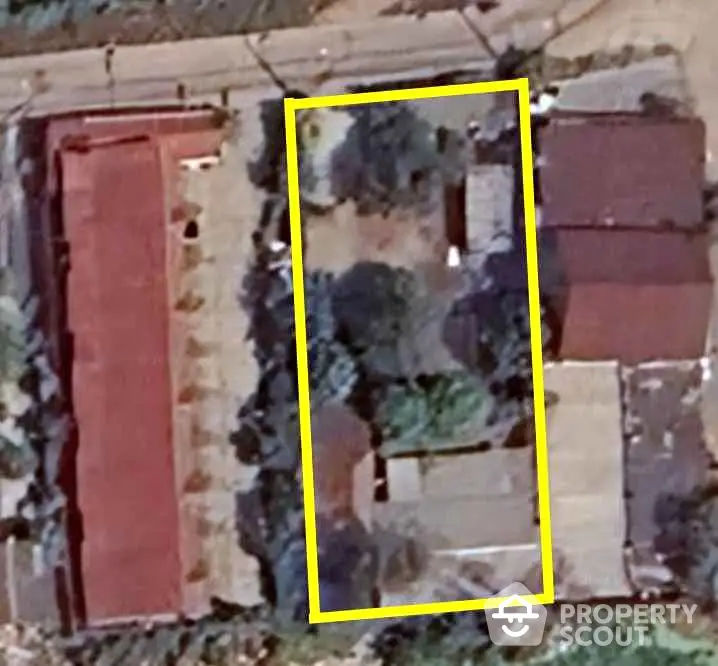 Aerial view of residential property with outlined boundary, showcasing potential for development.