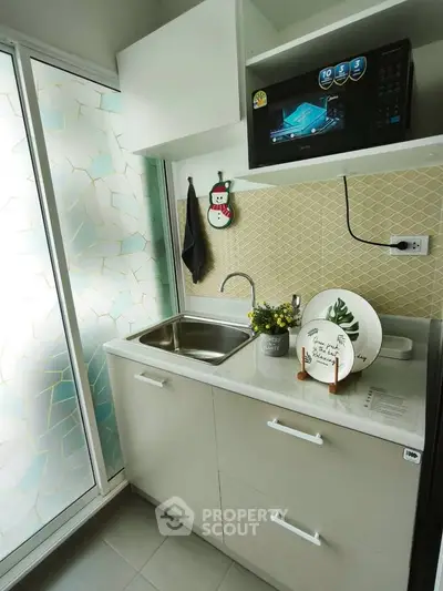 Charming compact kitchen with modern appliances and stylish decor