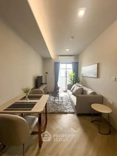 Modern living room with cozy sofa, dining table, and balcony view in stylish apartment.