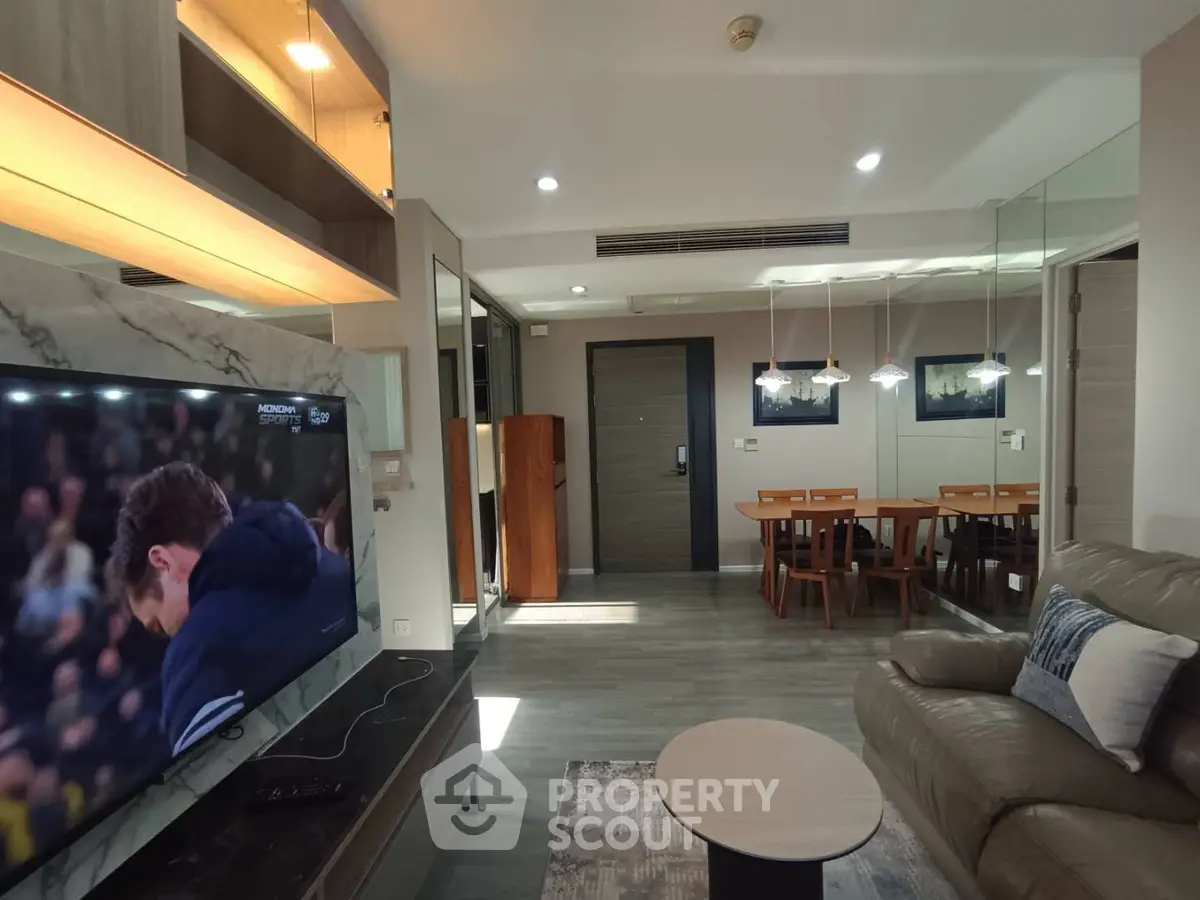 Modern living room with open layout, stylish furniture, and ambient lighting for a cozy atmosphere.