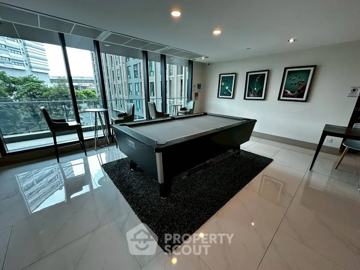 Modern apartment common area with pool table and city view