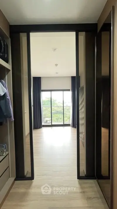 Spacious bedroom with large windows and balcony access, featuring modern closet space.