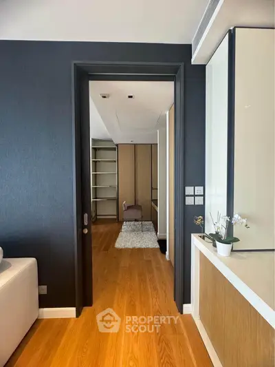 Modern interior with sleek design and wooden flooring, featuring a cozy study area.