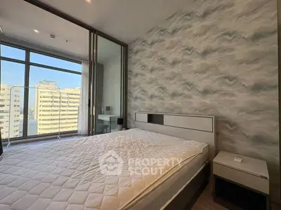 Modern bedroom with large window and stylish decor in high-rise apartment