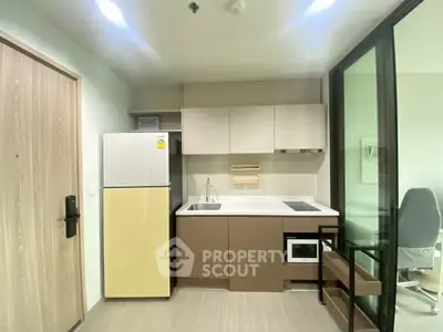 Modern kitchen with sleek cabinetry and built-in appliances in a stylish apartment.