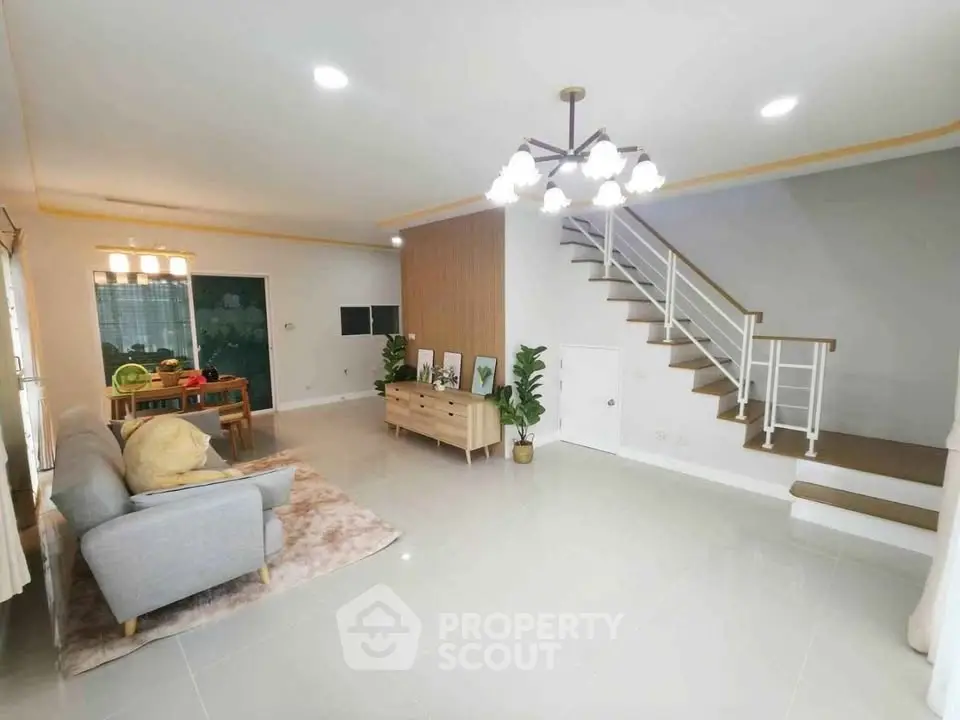 Spacious modern living room with elegant staircase and stylish decor