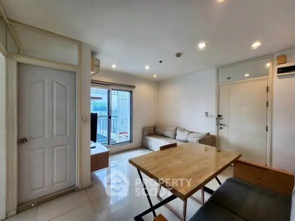 Modern living room with natural light and balcony access