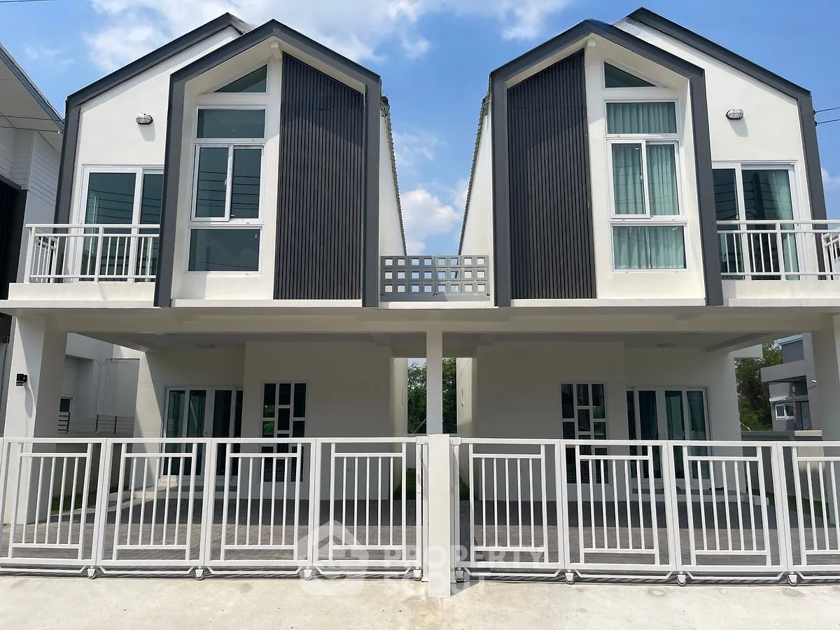 Modern duplex houses with sleek design and spacious balconies in a serene neighborhood.