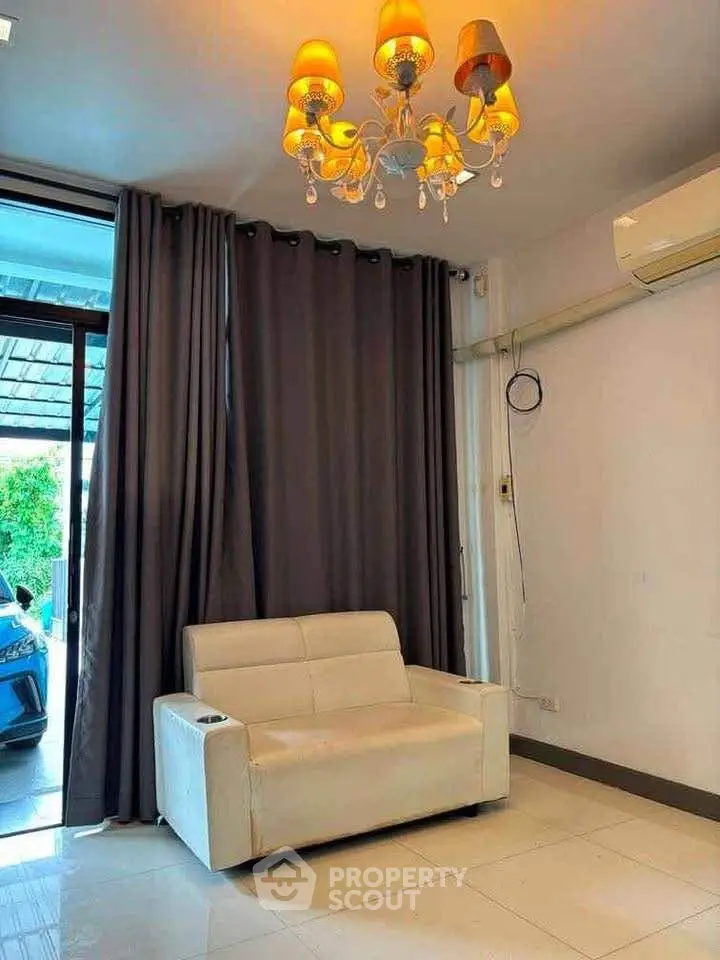 Cozy living room with elegant chandelier and modern sofa