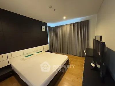 Modern bedroom with sleek design and large window curtains